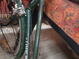 a bike that is parked next to a couch