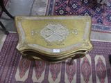 a small table with a gold and white design on it