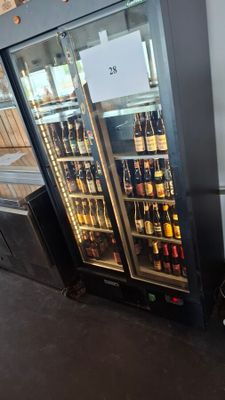 a refrigerator with a lot of bottles of beer inside of it