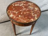 a small table that has a marble top on it