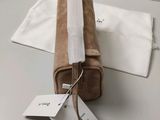 an image of a tan toilet bag with a tag on it