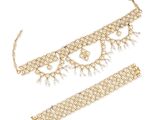 a gold necklace and bracelet set with pearls on a white background