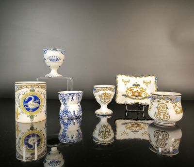 many different types of vases and cups on the table
