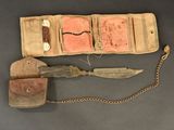 a knife and other items in a case on a table