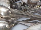 a lot of silver spoons and spoon spoons on the table