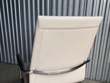 an image of a white office chair sitting on top of a metal floor