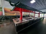 tables and chairs in a restaurant with a red roof over them