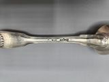 a close up of a spoon and fork on a table