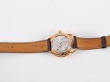 an image of a person holding a watch on a white surface