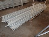 a pile of steel rods sitting on a pallet in a warehouse