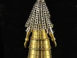 an image of a gold bell ornament on a black background