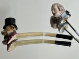a figurine of a man with a top hat and cane next to a pair of scissors