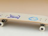 a white skateboard with blue and purple designs on it
