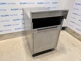 a silver metal cabinet sitting on top of a floor next to a wall