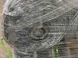 a roll of wire wrapped in plastic on top of a pallet