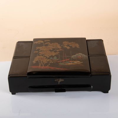 a black box with a painting on it on a white surface