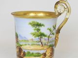 a cup that has a painting on it on it