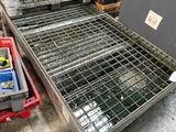 a large metal crate sitting on the floor next to other crates