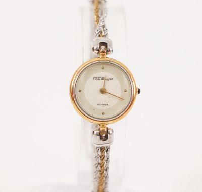 EMILE PEQUIGNET Montre de dame en acier et métal doré, boiti…