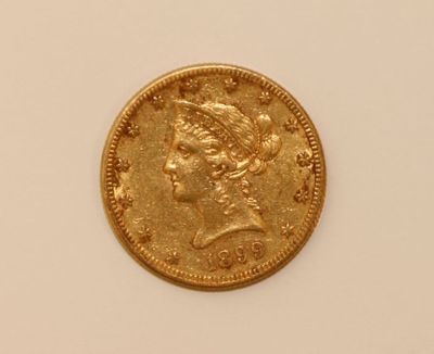 a close up of a gold coin on a white surface