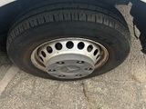 a white car with a flat tire on the street