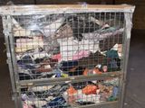 a metal cart with many items in it in a warehouse