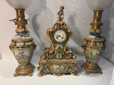 three vases and a clock sitting on a table