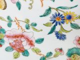 a close up of a plate with flowers and birds on it