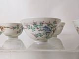 three bowls sitting on top of a glass shelf
