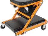an orange and black stool sitting on top of a black chair