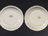 two white plates sitting on top of each other on a table