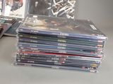 many dvds stacked on top of each other on a table