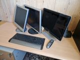 two computer monitors and a keyboard on a desk