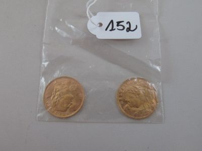two gold coins in a plastic bag with a price tag