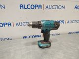 a cordless drill is shown on a table in front of a sign