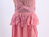 a pink dress with ruffles on a mannequin stand