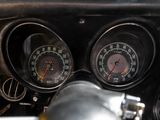 a close up of a car dashboard with a speedometer and gauges