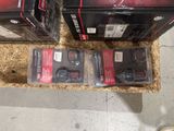 two boxes of power tools on the floor
