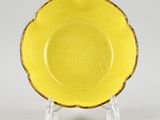 a yellow bowl with a design on the rim