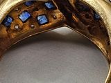 an image of a gold ring with blue and white stones