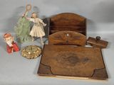 a small wooden box with a doll and other items on it