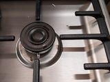 a metal stove top with a metal burner on it