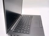 a laptop computer sitting on a table with a keyboard