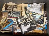 a box full of old photos of people and buildings