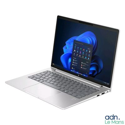 a silver laptop with a blue flower on the screen