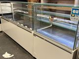 a glass display case in the middle of a store