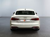 the rear end of a white audi sedan parked in a room