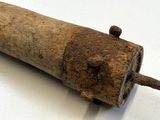 un vieux bâton en bois d'où sort un clou