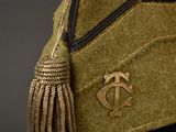 a close up of a hat with a tassel on it