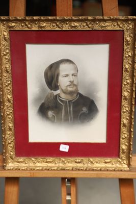 painting of a man with a beard in a gold frame on a easel